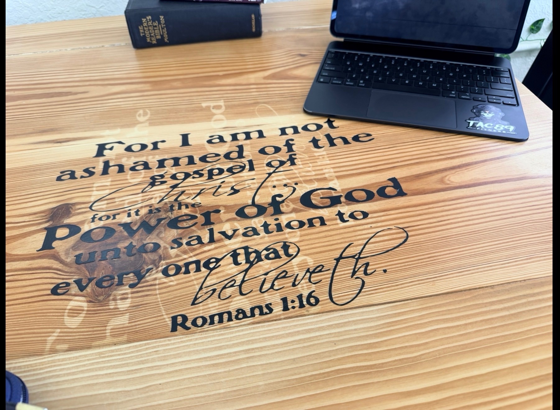 A wooden table at John 3:16 Caffe with scripture etched into the surface