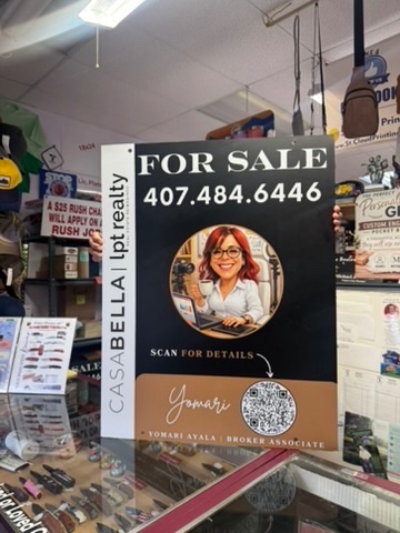 Close-up of a finished custom For Sale sign for CasaBella lpt realty displayed inside the St. Cloud Printing shop