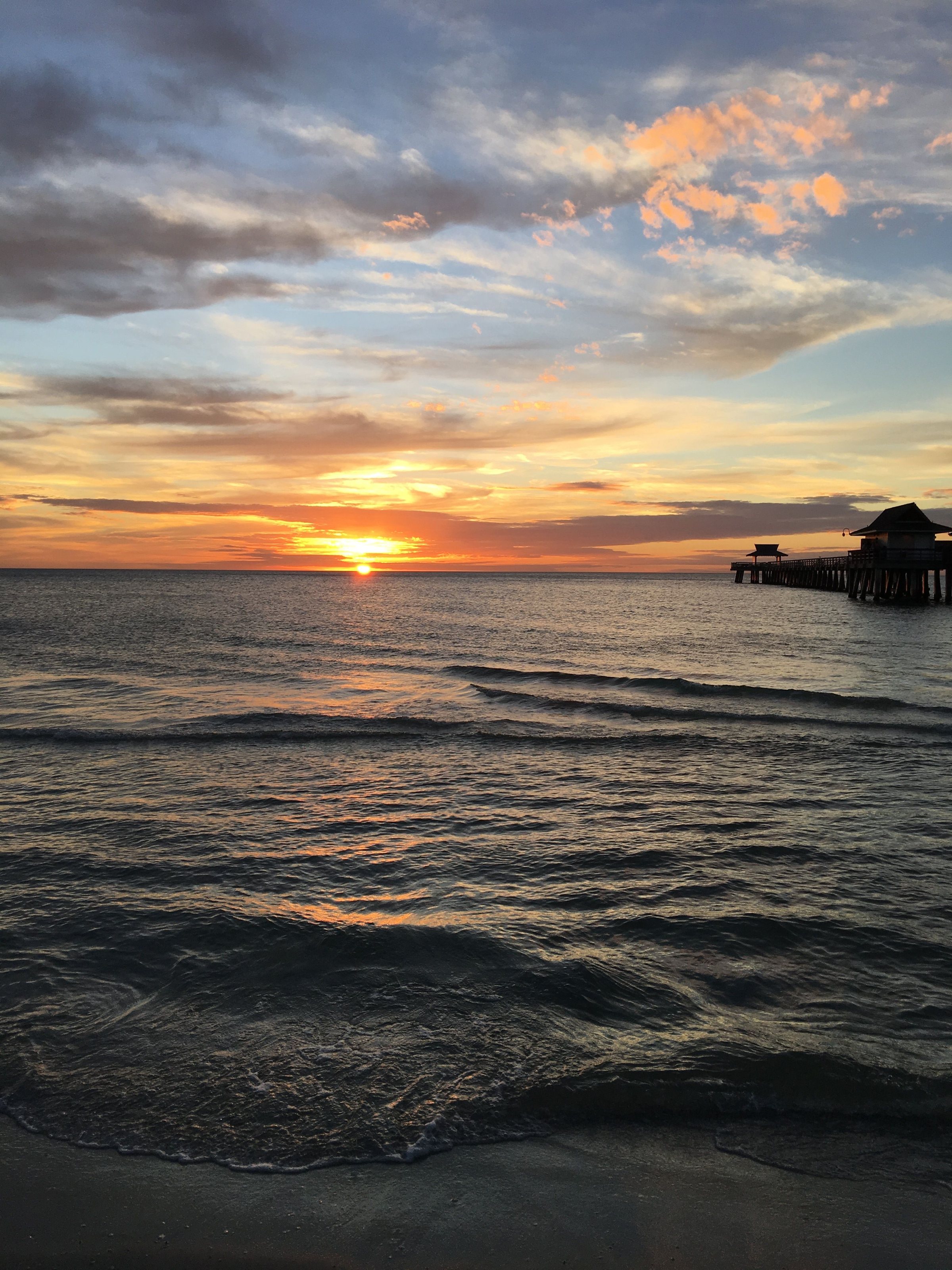 Sunset over the Gulf of Mexico at Naples Pier, Florida