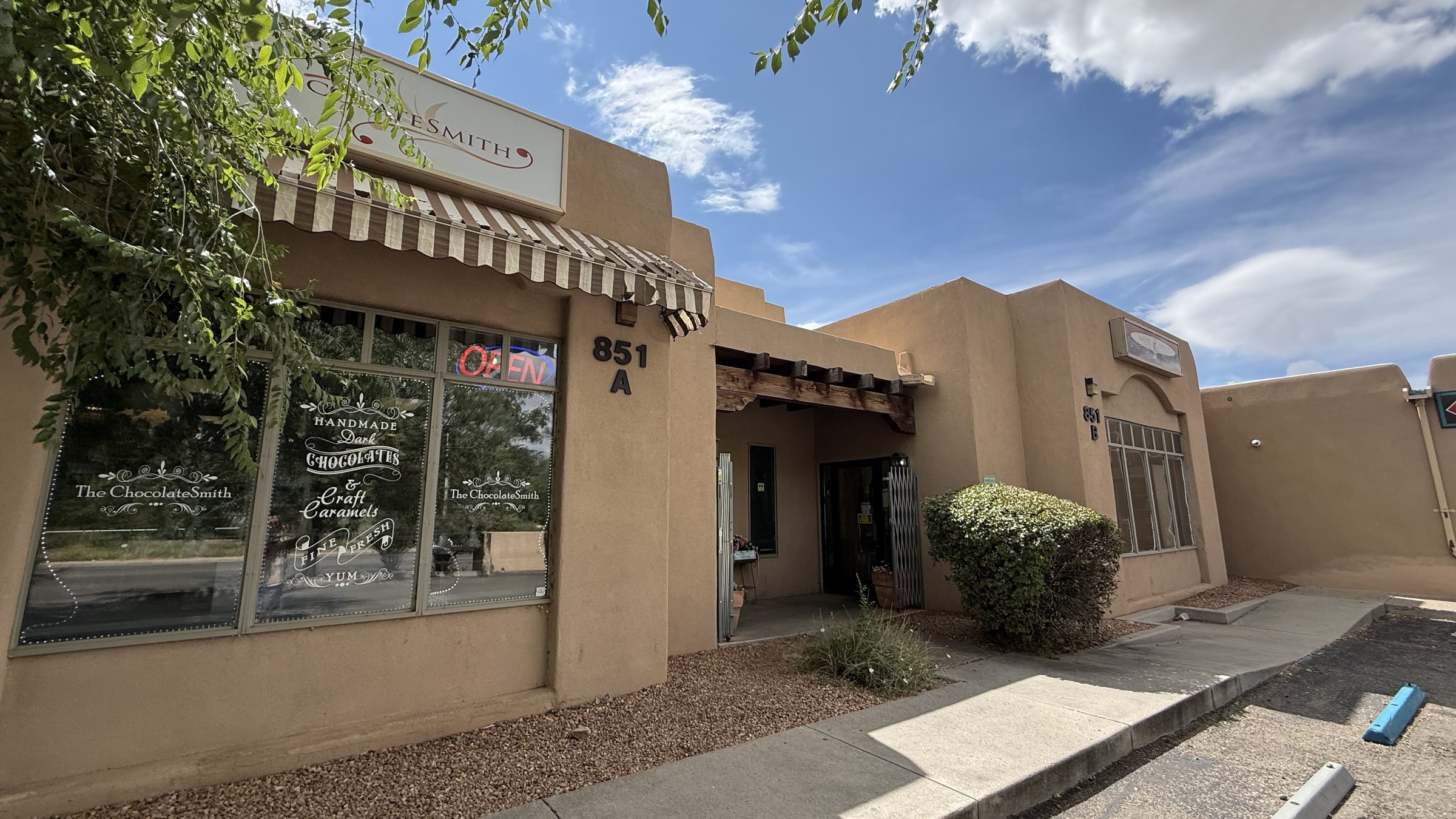 The ChocolateSmith storefront, a tan stucco building with a striped awning and the address 851 A on the wall