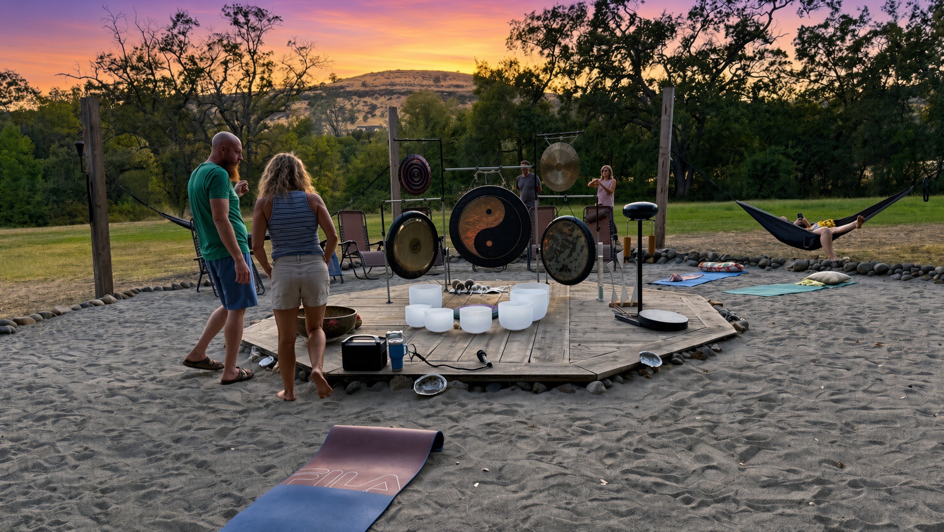 Hammocks around the sand circle at The Meadow during sunset