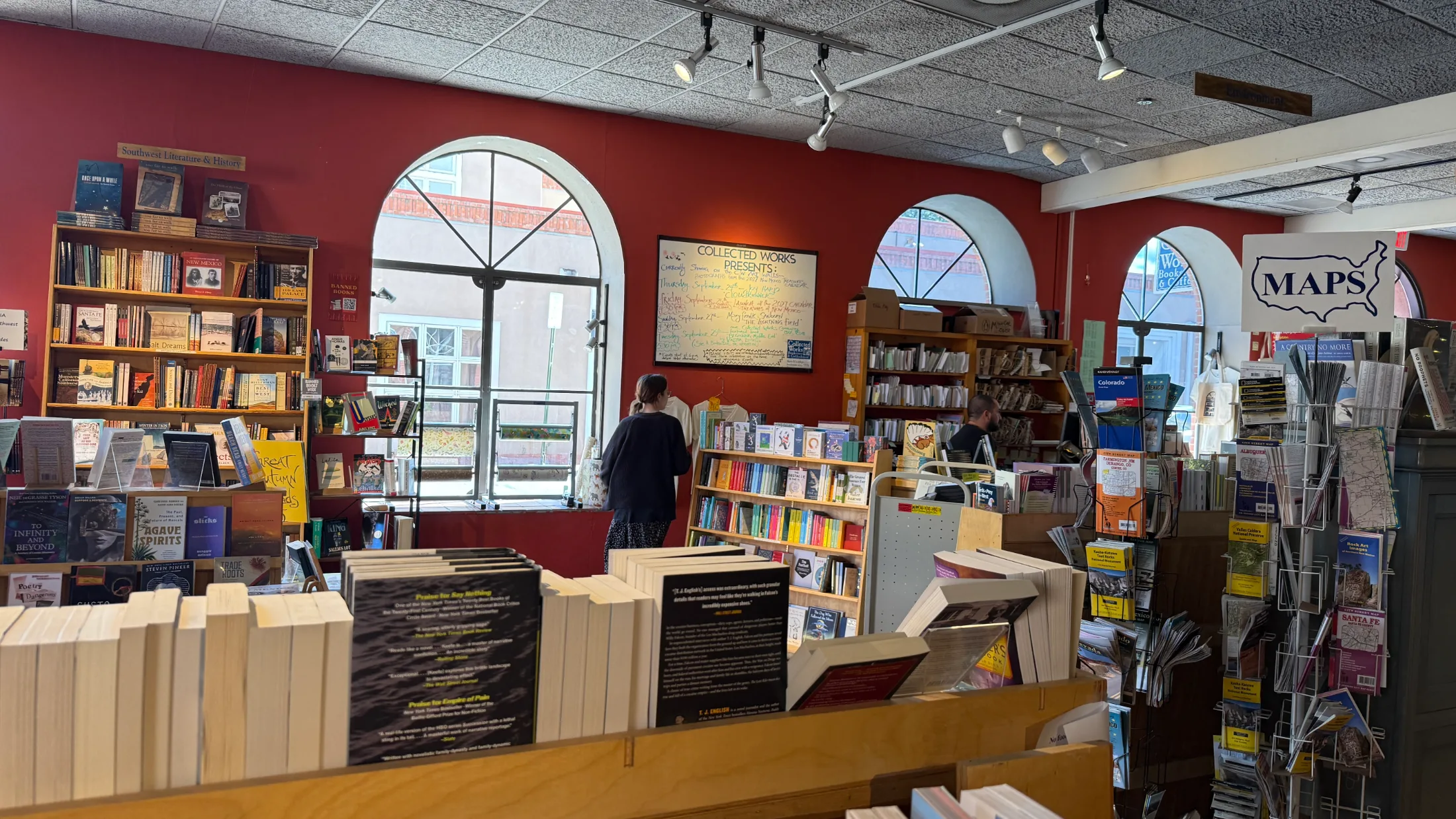 Southwest Literature and History section at Collected Works, arched windows, Collected Works Presents events board on the wall
