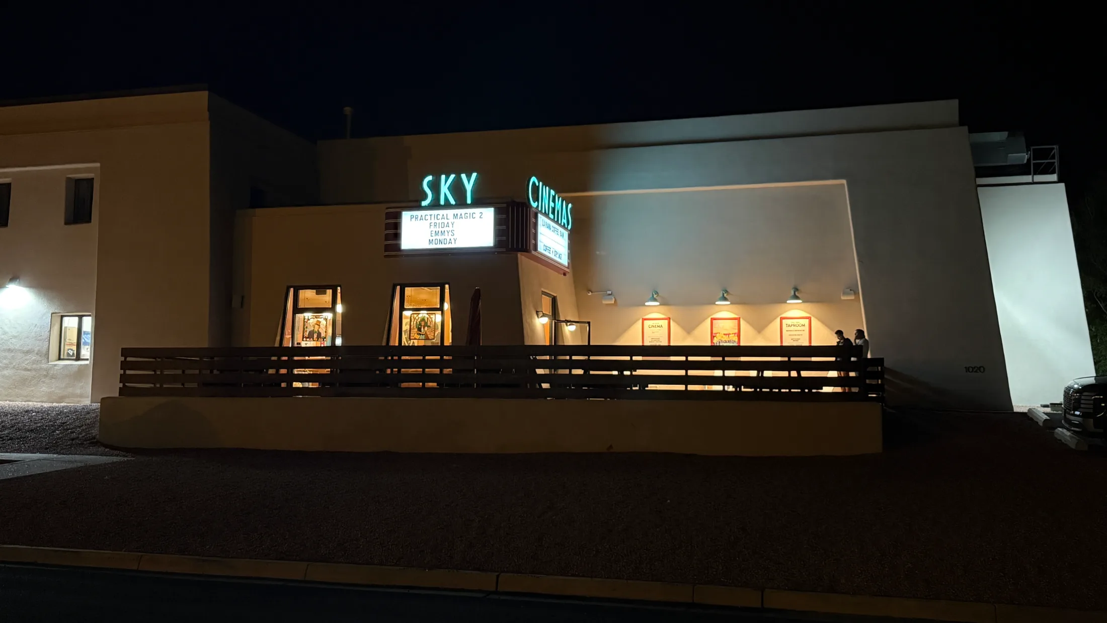 Sky Cinemas marquee lit in teal at night, showing Practical Magic 2 and Emmy screenings on the board