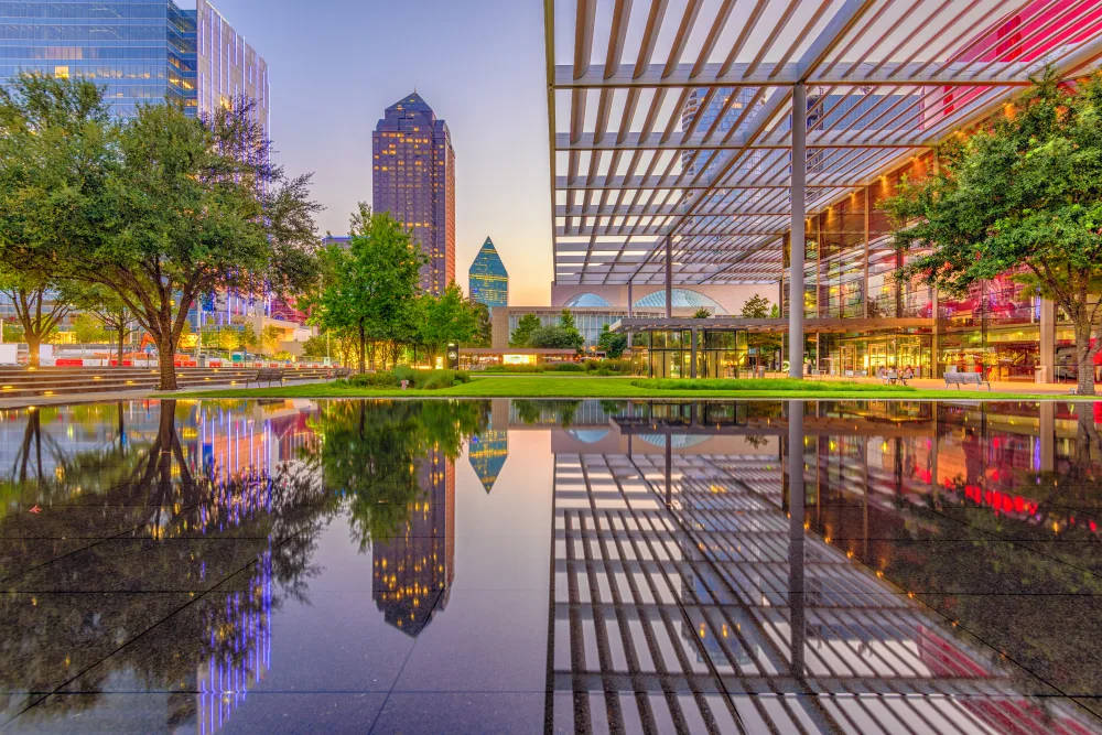 Dallas Arts District reflecting pool at dusk, towers mirrored in still water