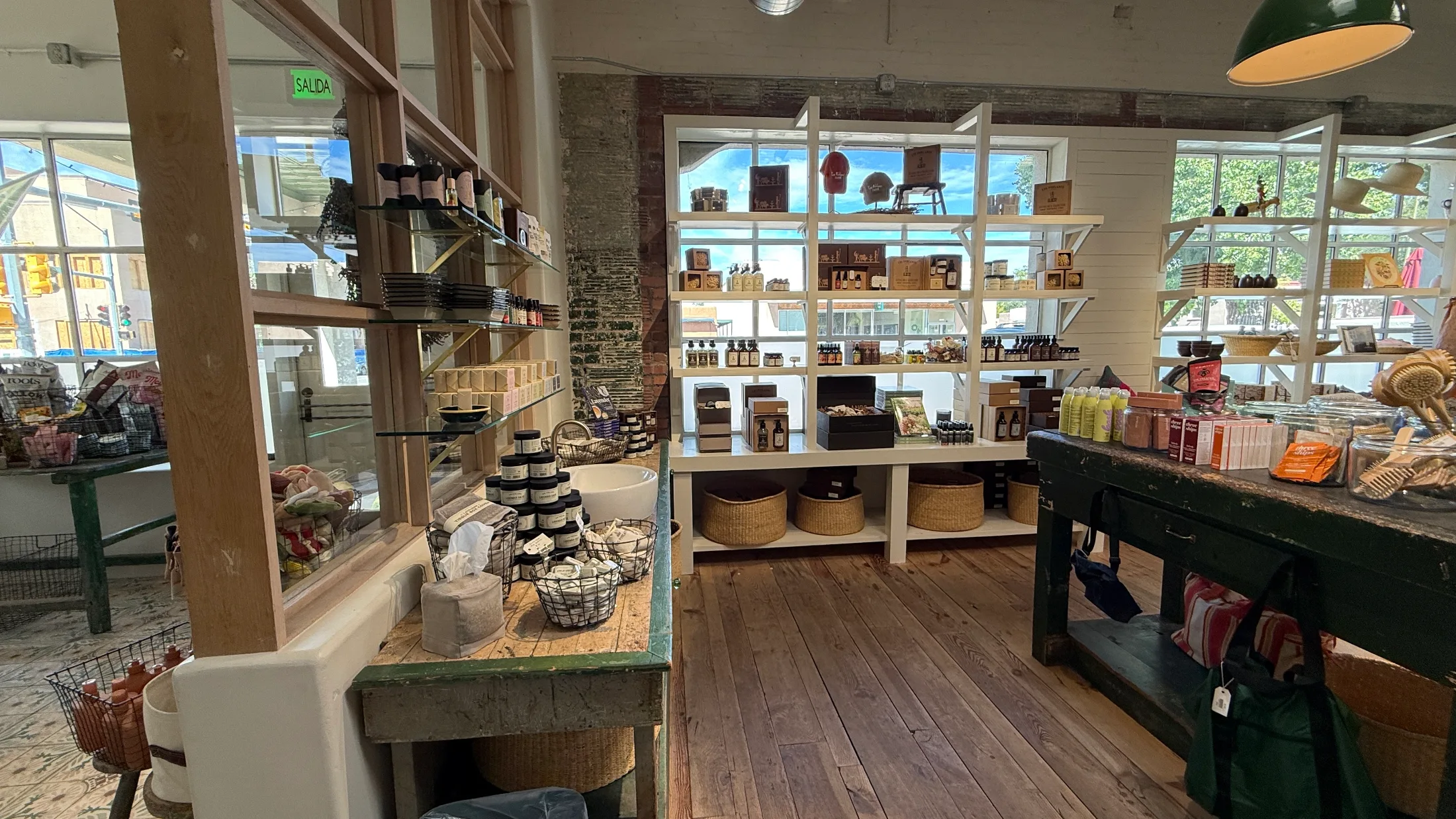 Body care and gift section of Farm Shop Norte — shelves of lavender soaps, oils, and creams alongside woven baskets and a farmhouse sink display
