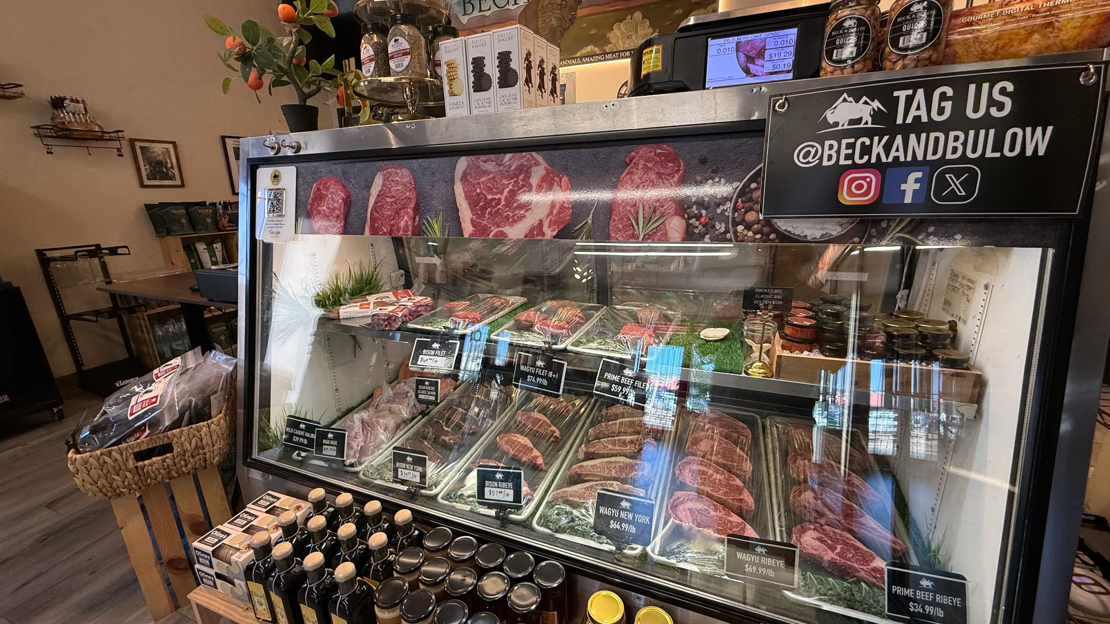 Beck and Bulow glass display case showing Bison Filet, Wagyu Filet, Prime Beef Filet, Wagyu New York, Wagyu Ribeye, and Prime Beef Ribeye with price tags
