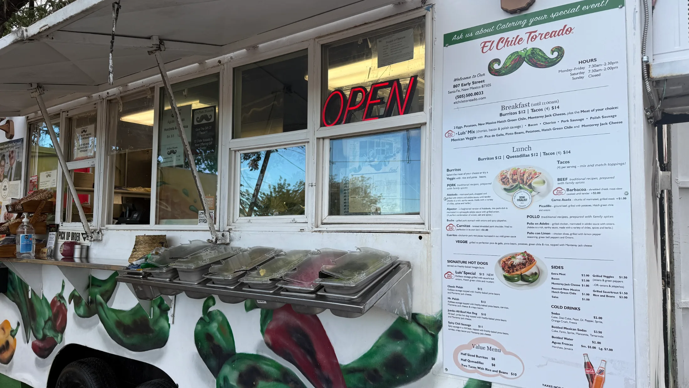 El Chile Toreado food truck at 807 Early Street, Santa Fe, with the menu board visible and the OPEN sign lit in red