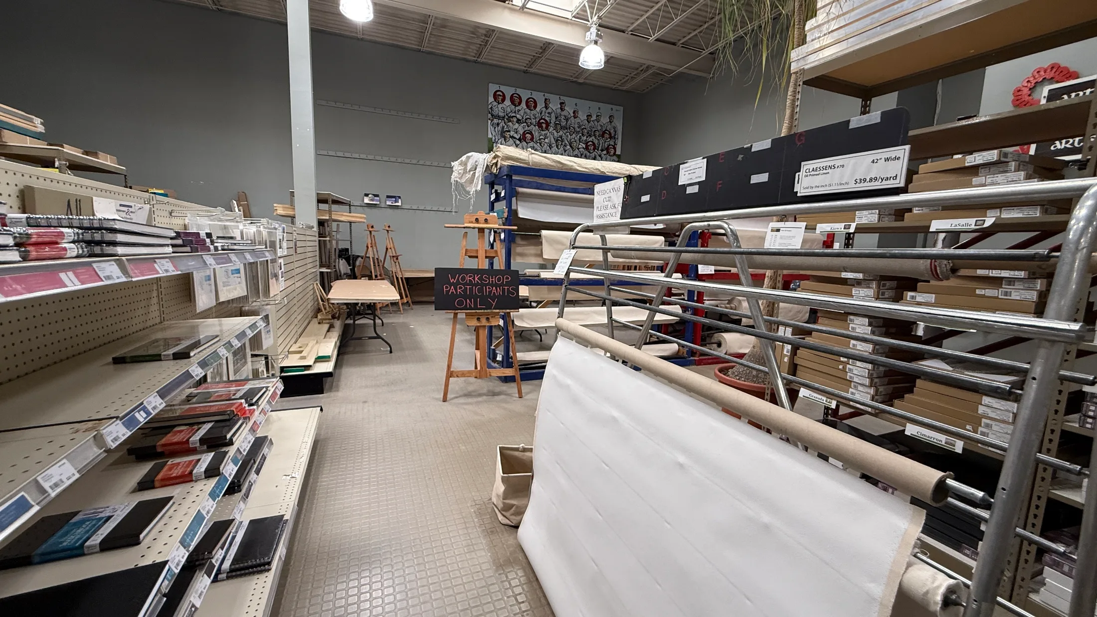 Artisan Santa Fe canvas and sketchbook section with rolls of primed linen, easels, and a Workshop Participants Only sign