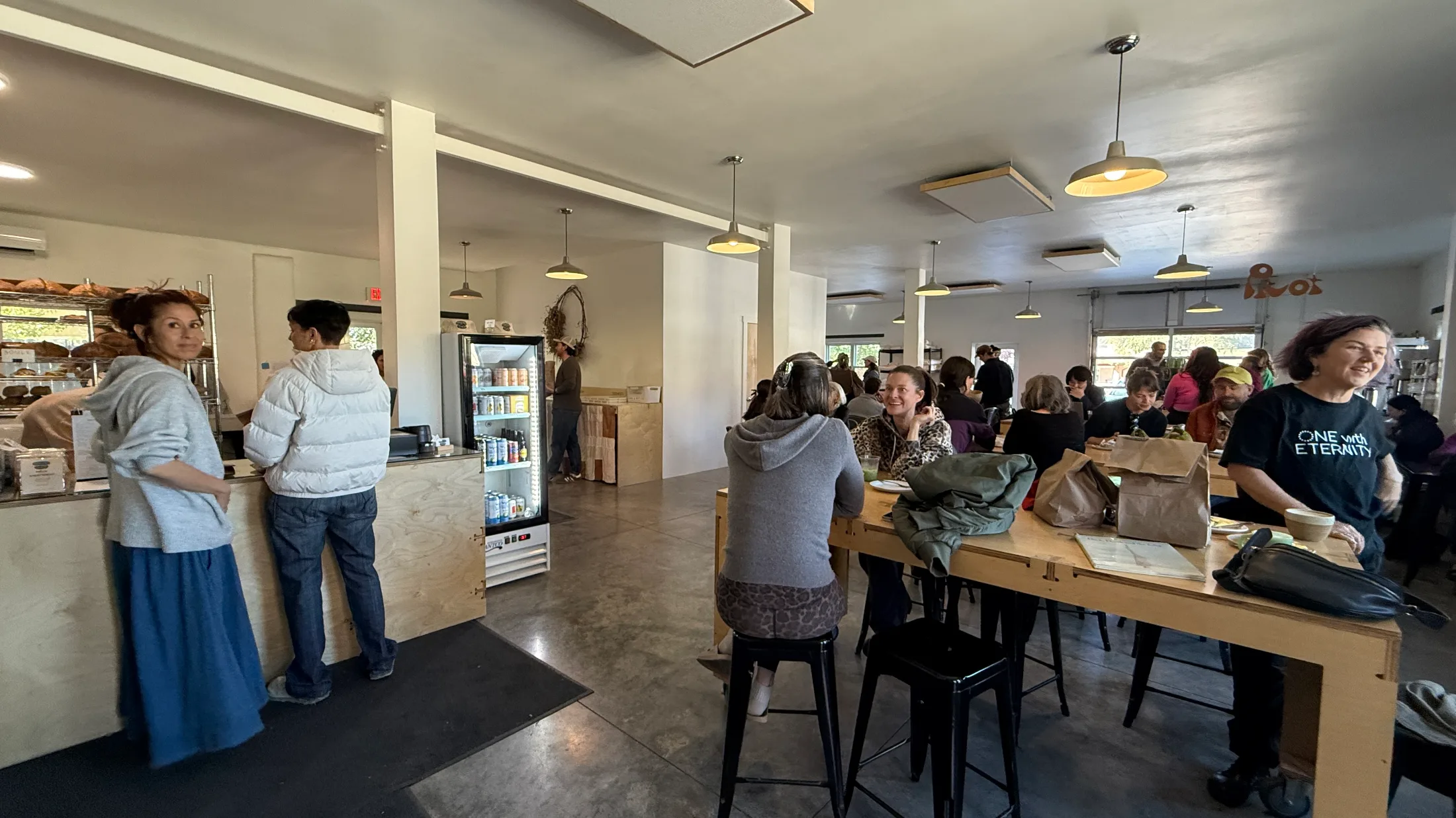 Packed communal tables at Bread Shop on a busy weekday morning