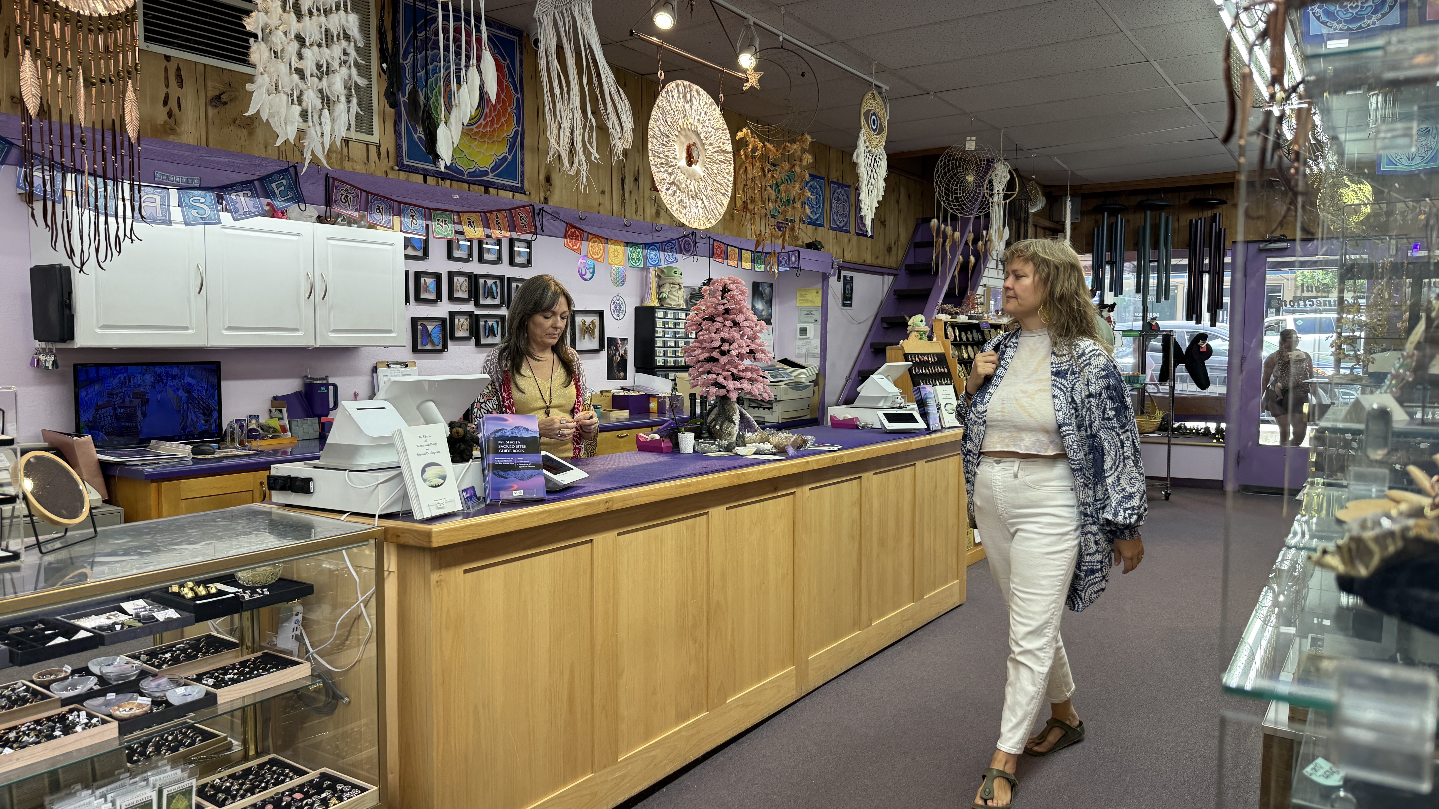 Purple checkout counter at Soul Connections with jewelry cases and dreamcatchers