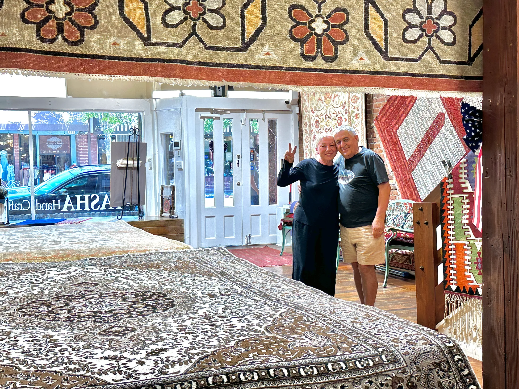 Hasan and Jale Safak, owners of Pasha Hand Crafted Rugs, standing inside their Downtown Chico shop