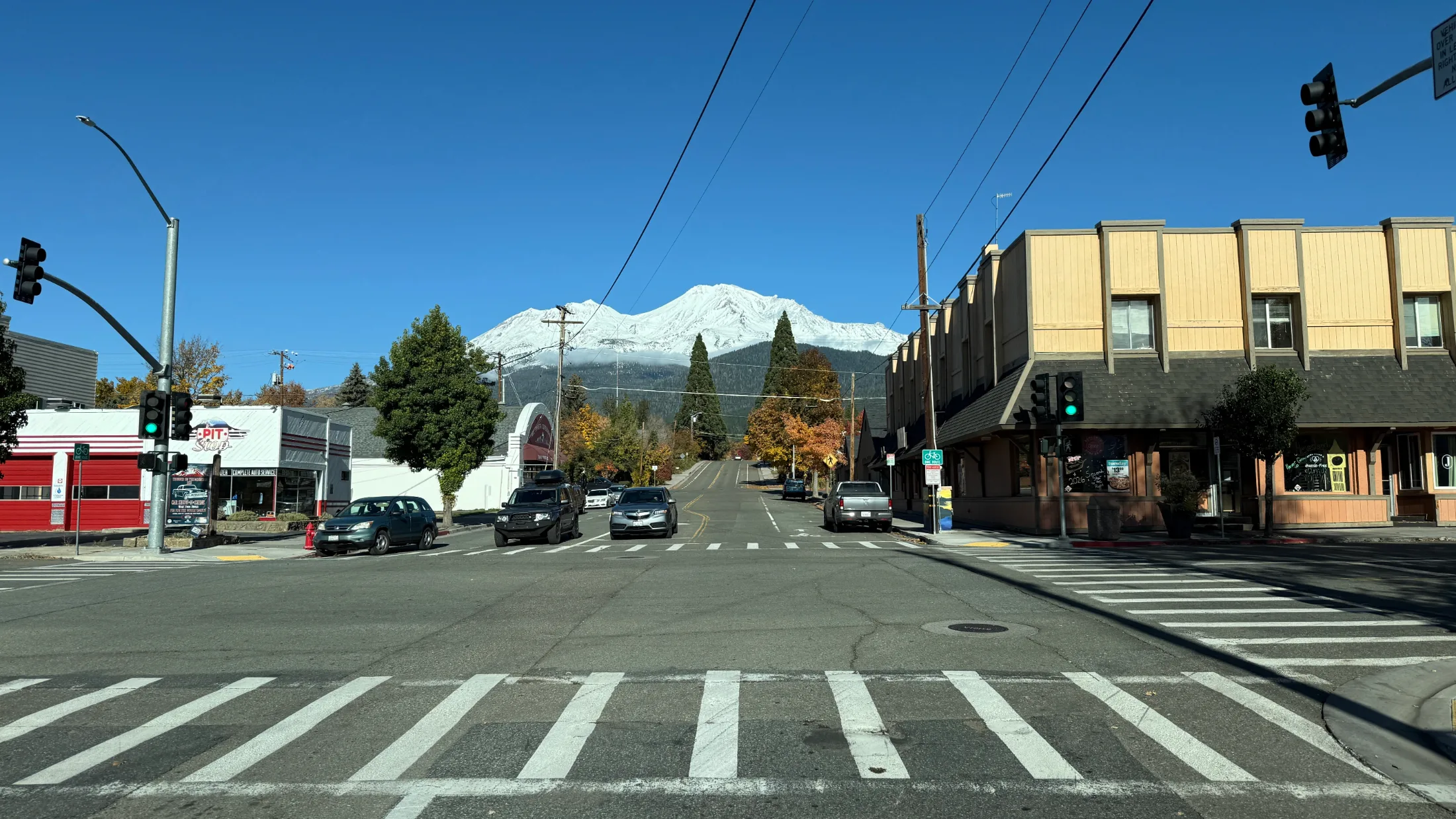 Mount Shasta Boulevard intersection with the snow-capped summit framed at the end of the road on a clear autumn day