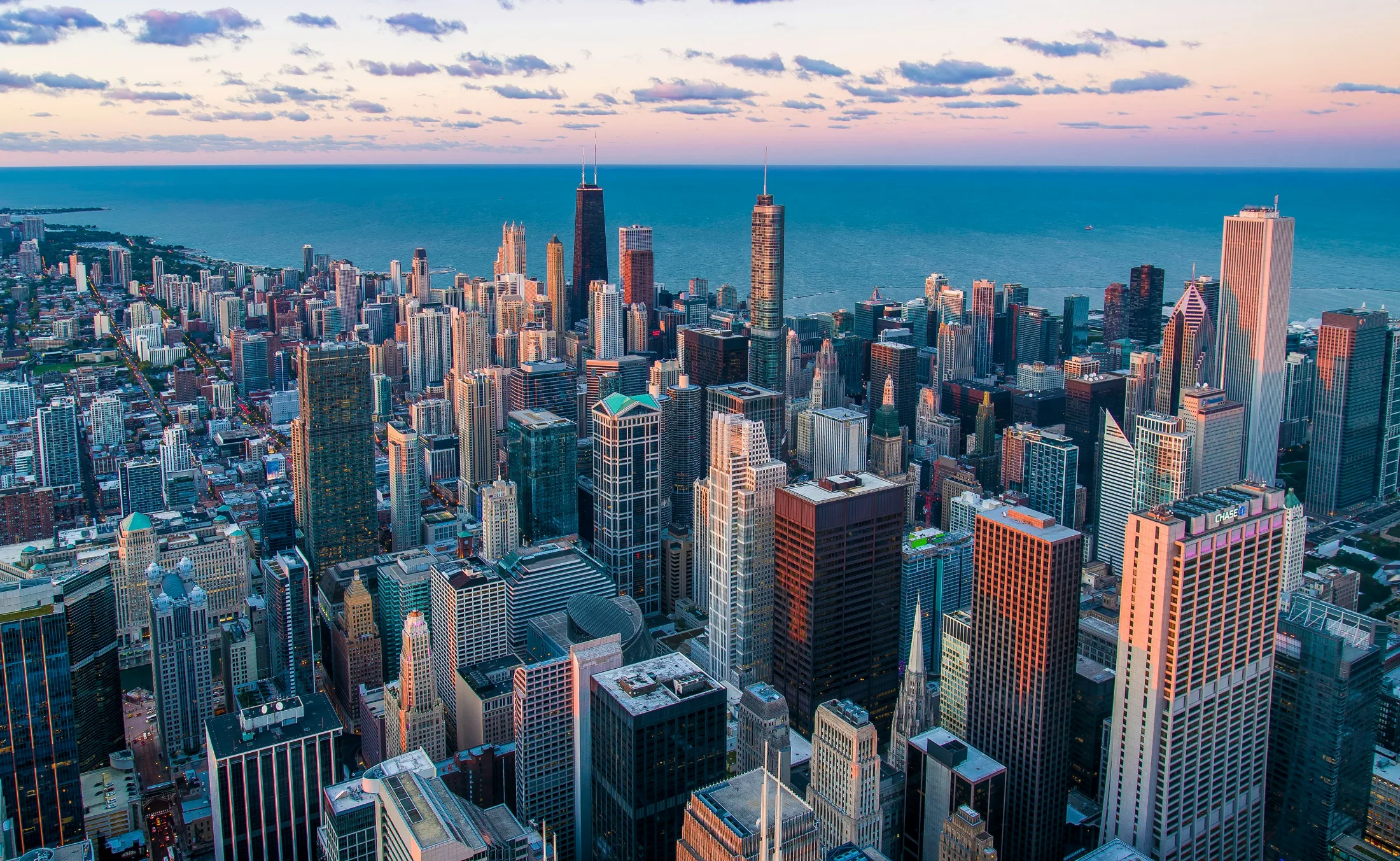Aerial view of the Chicago skyline at dusk with Lake Michigan in the background