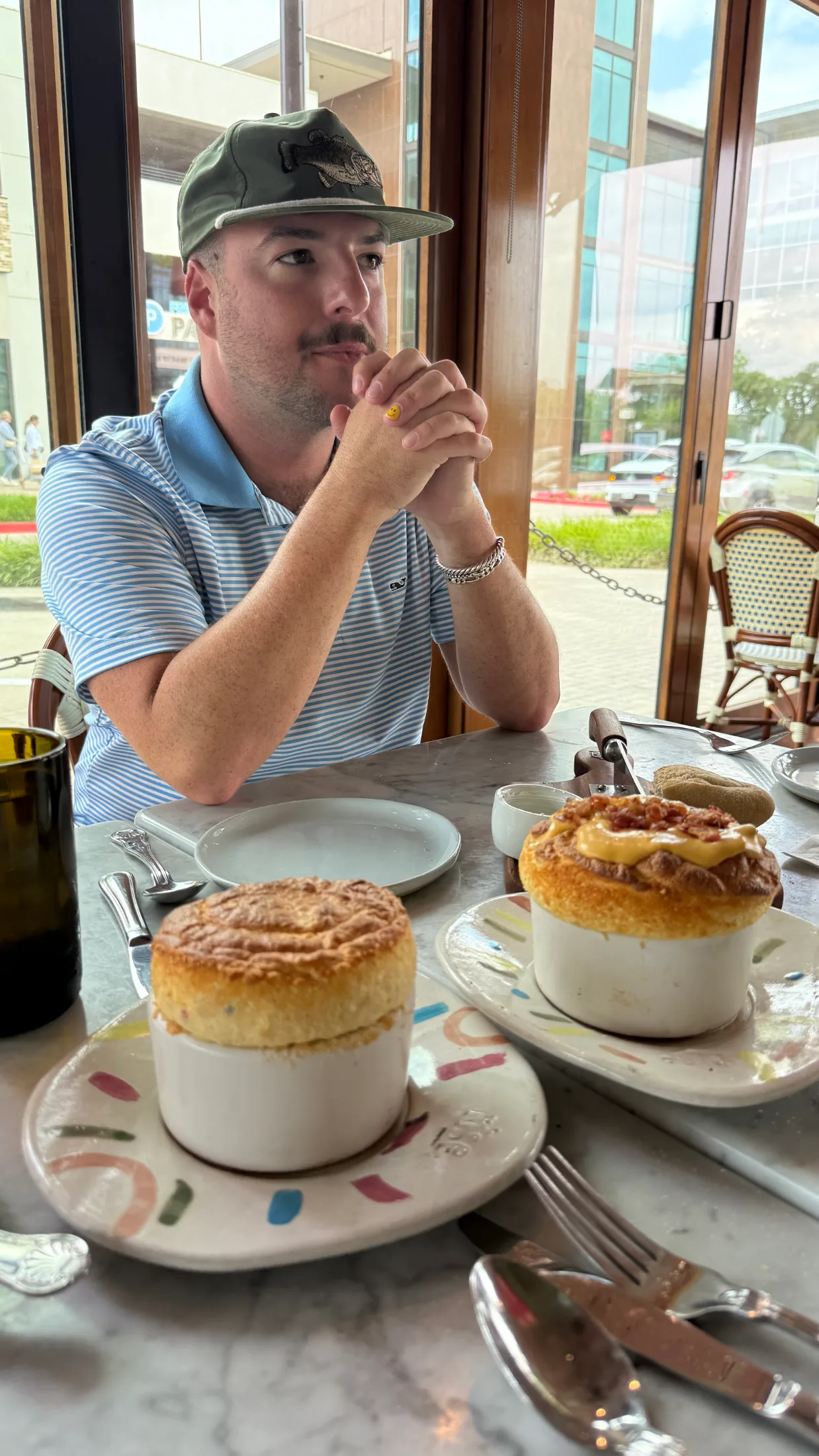 The Mayor seated at Rise Soufflé Fort Worth with two soufflés on the table in front of him