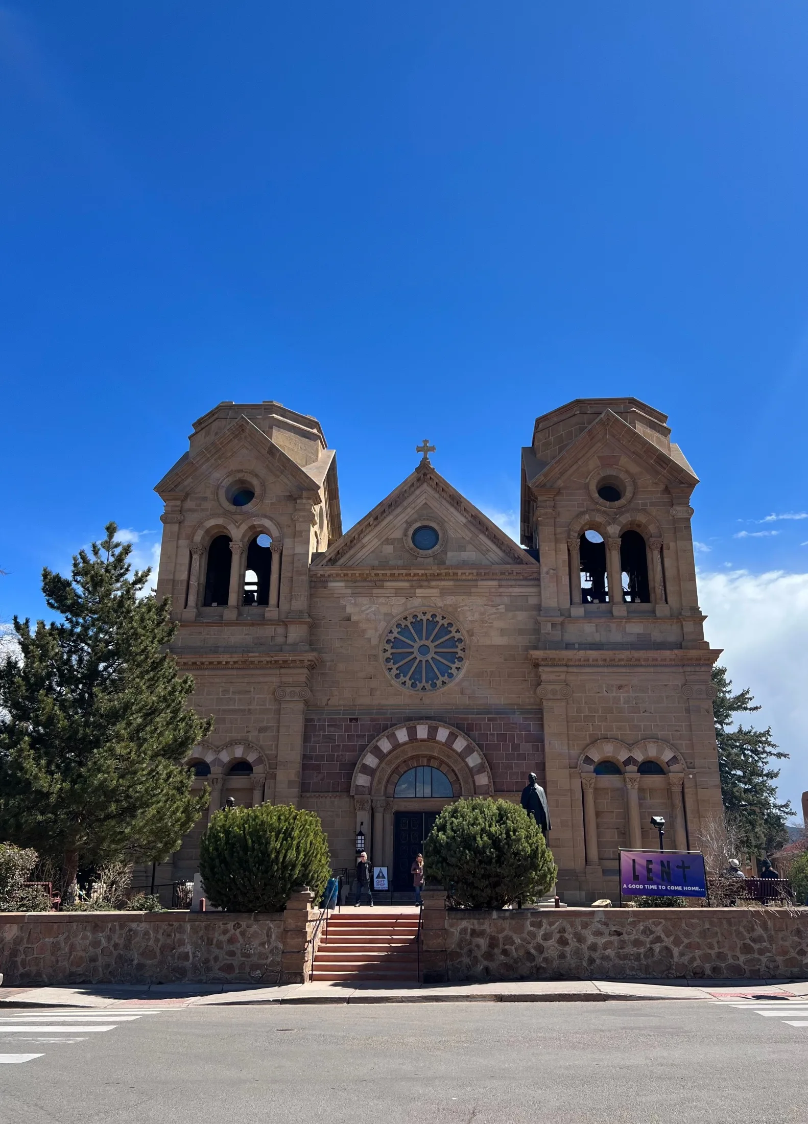 Cathedral Basilica of Saint Francis of Assisi against a deep blue New Mexico sky