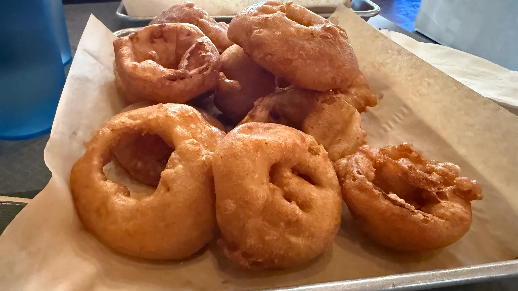 A tray of thick, golden beer-battered onion rings at Woody's Brewing Company in Redding, CA