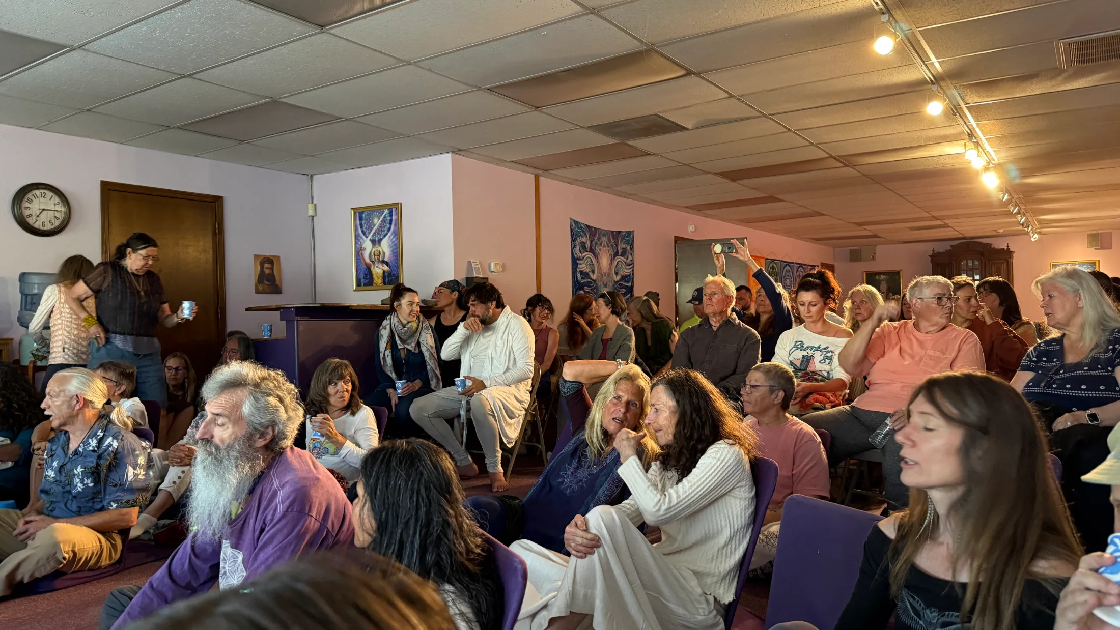 A packed crowd of Mount Shasta community members seated on chairs and the floor during the Q&A portion of the Simrit workshop