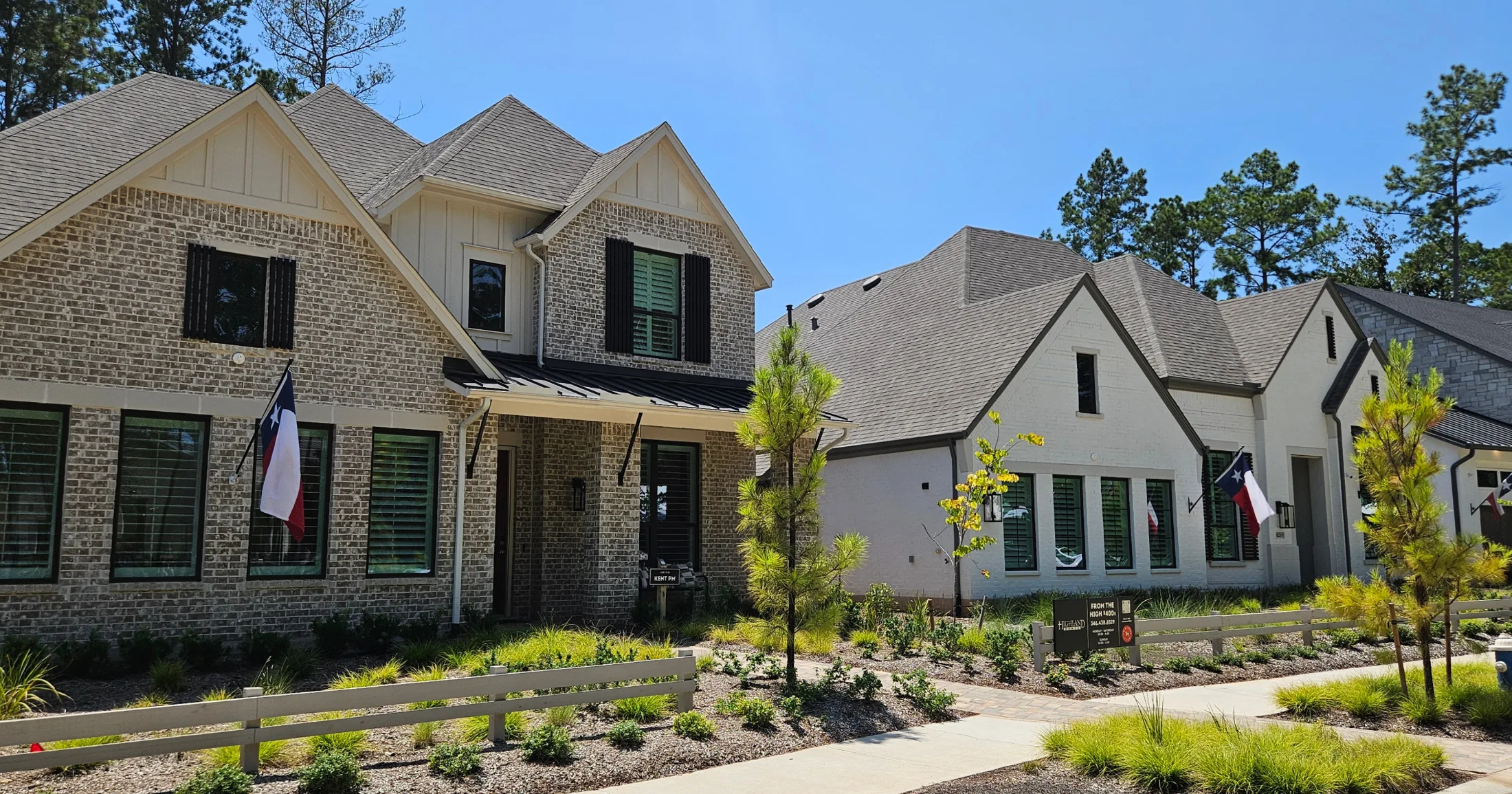 Highland Homes model homes on Folks Street with brick and white stucco facades and Texas flags