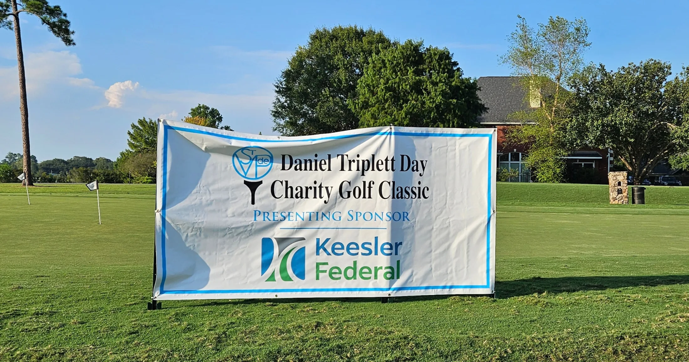 Daniel Triplett Day Charity Golf Classic banner on the fairway with Keesler Federal as presenting sponsor