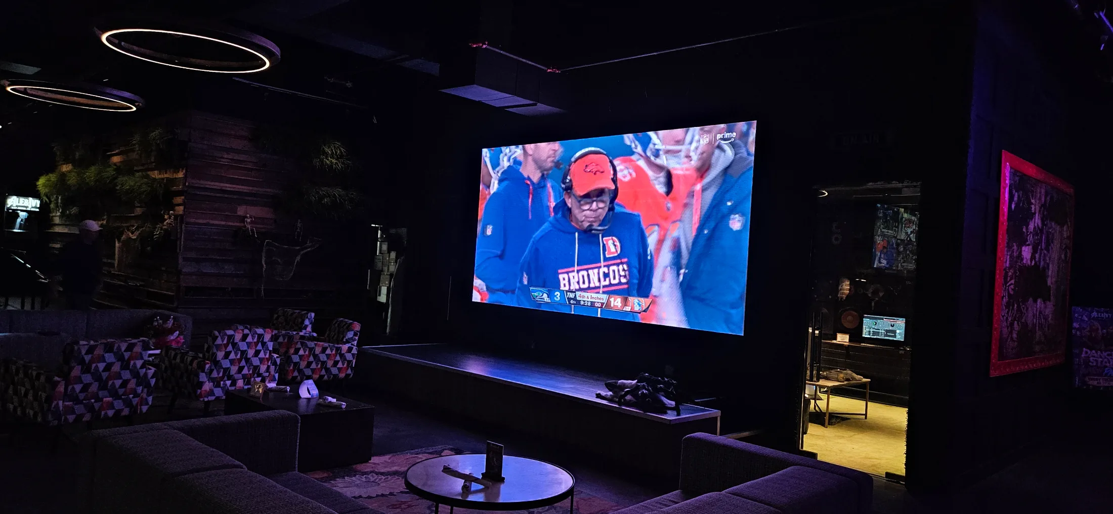 Large projection screen showing the Thursday night NFL game in the lounge area of Ale and Ivy