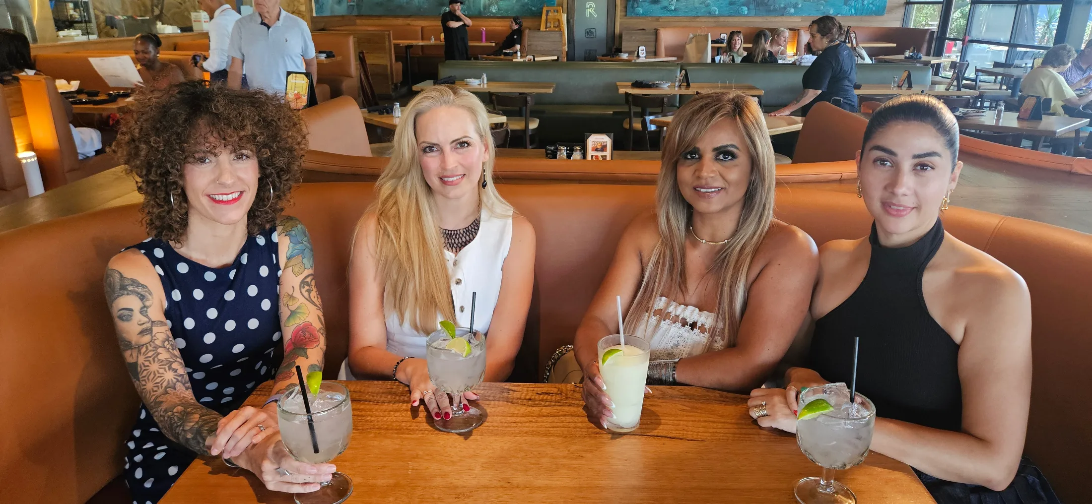 Four women who recently relocated to The Woodlands from Spain, Guadalajara, Colombia, and Mexico, enjoying margaritas in the dining room at Escalante's Hughes Landing