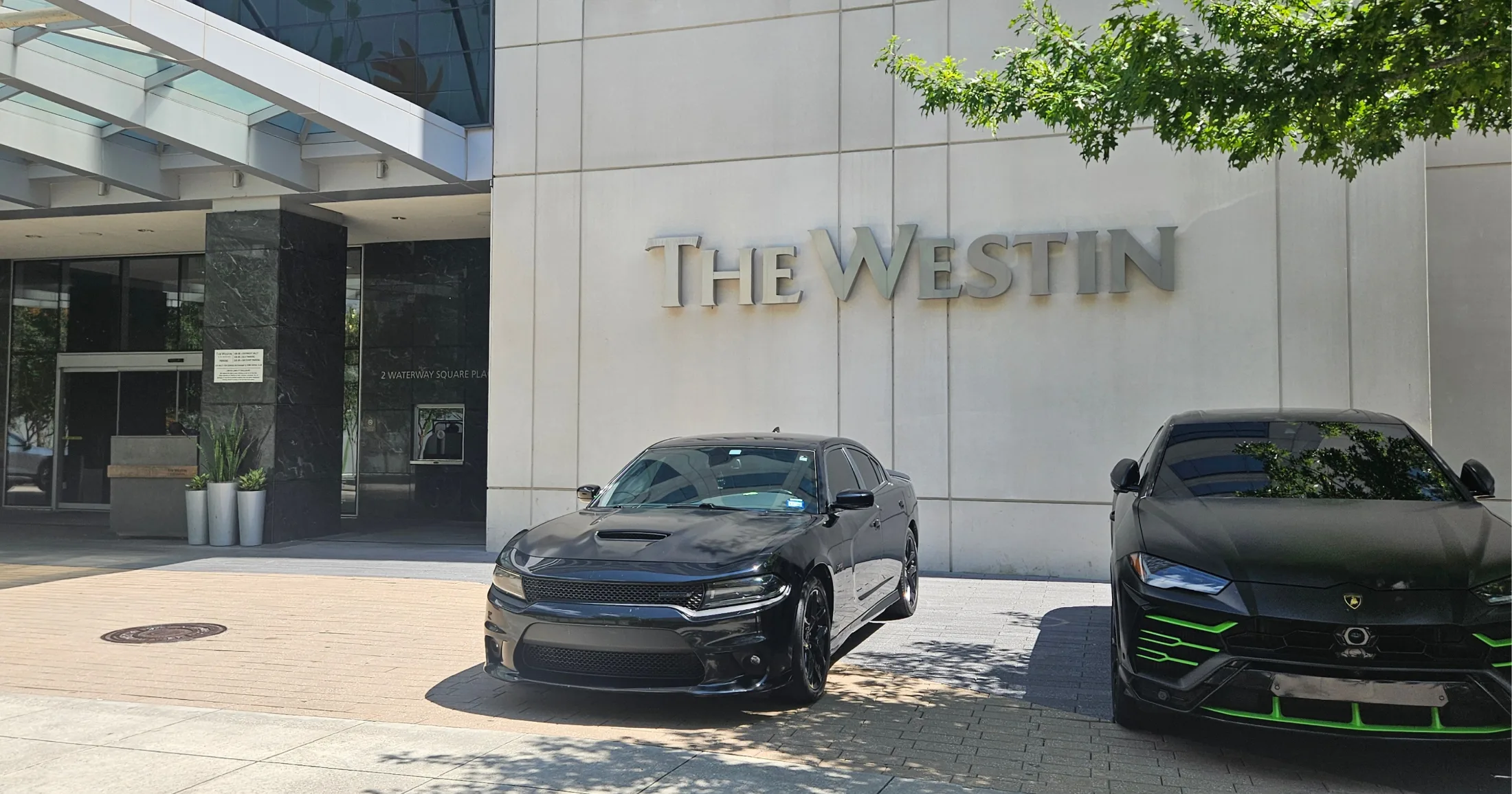 The Westin at 2 Waterway Square Place with luxury vehicles out front