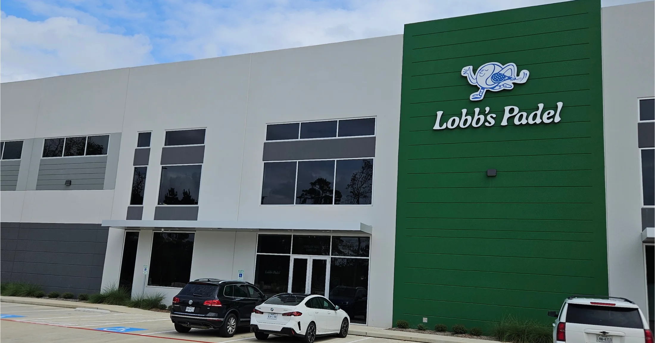 Lobb's Padel exterior at Dudley Sports Plaza on FM 1488, The Woodlands, with the green branded facade and logo visible