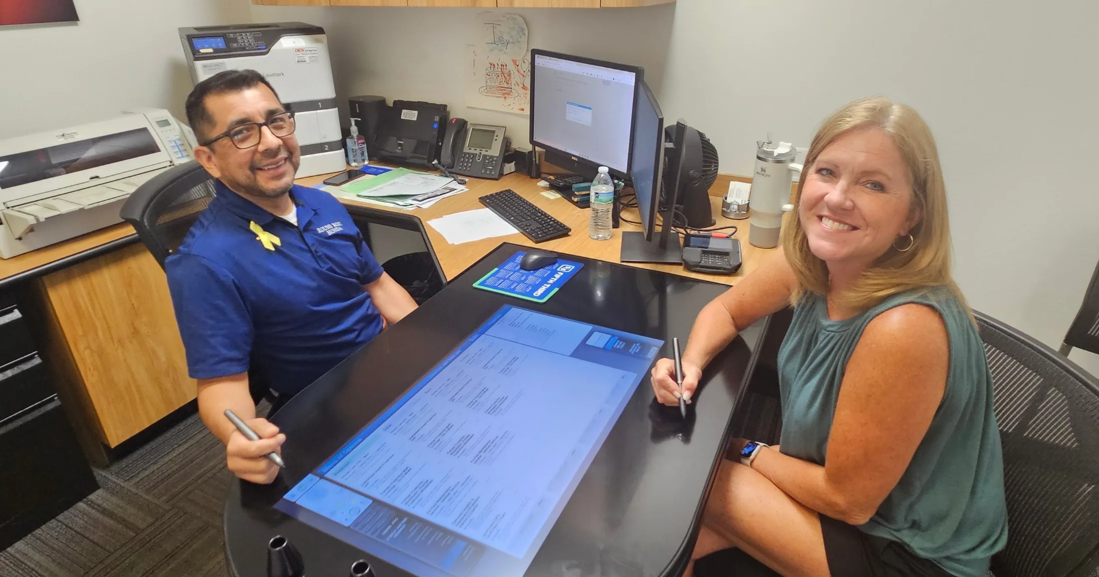 Jennifer Steele signing paperwork with Jason Jackson at Round Rock Honda