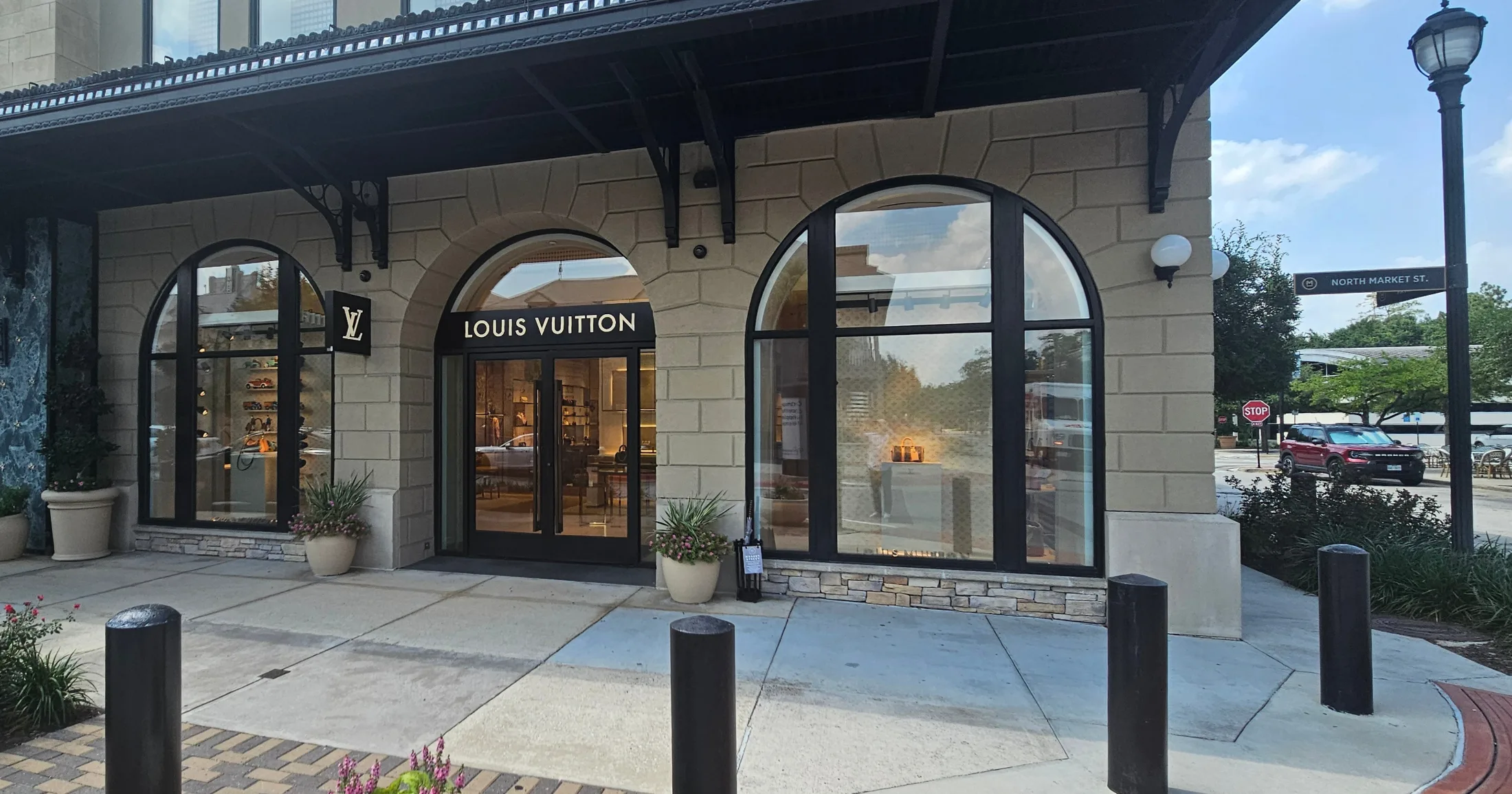 Louis Vuitton storefront on North Market Street with arched windows and warm interior lighting visible through the glass