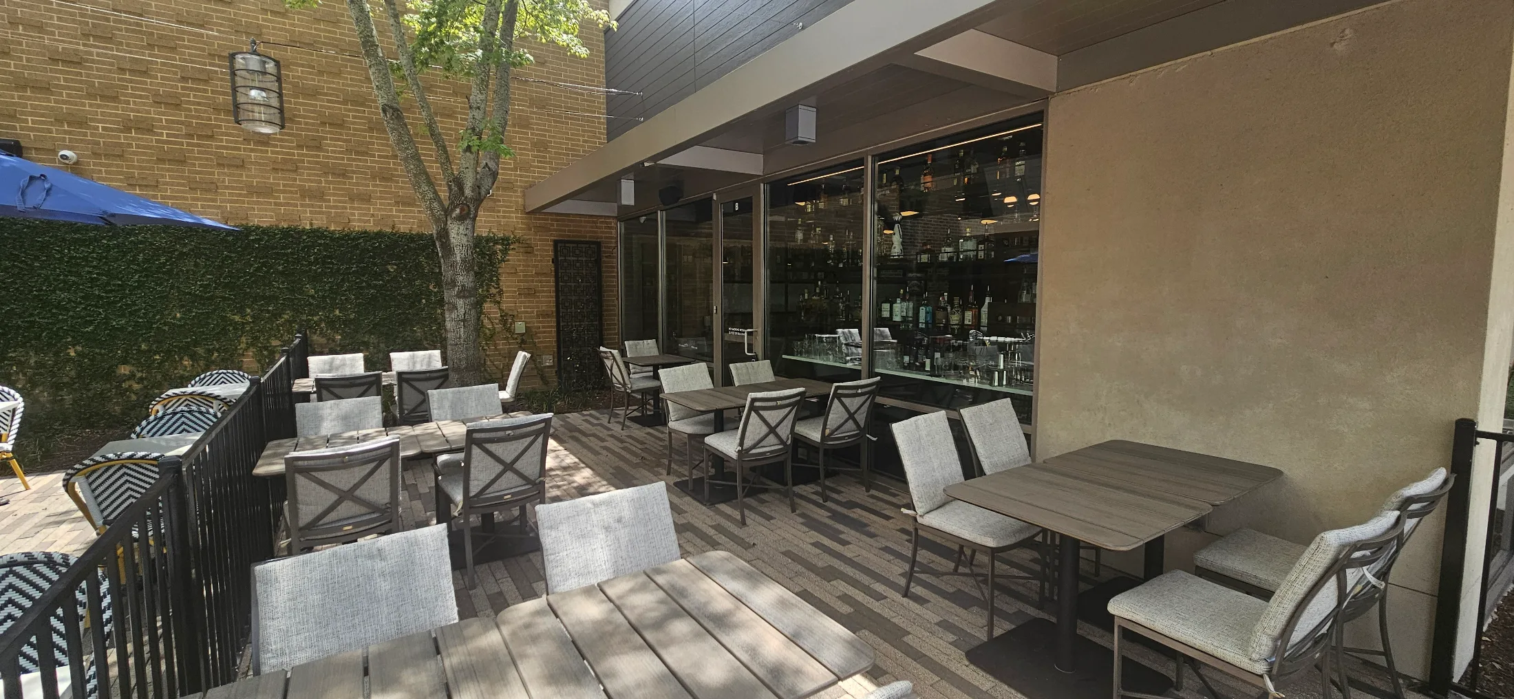 Outdoor patio at Schilleci's New Orleans Kitchen with shaded deck and ivy wall