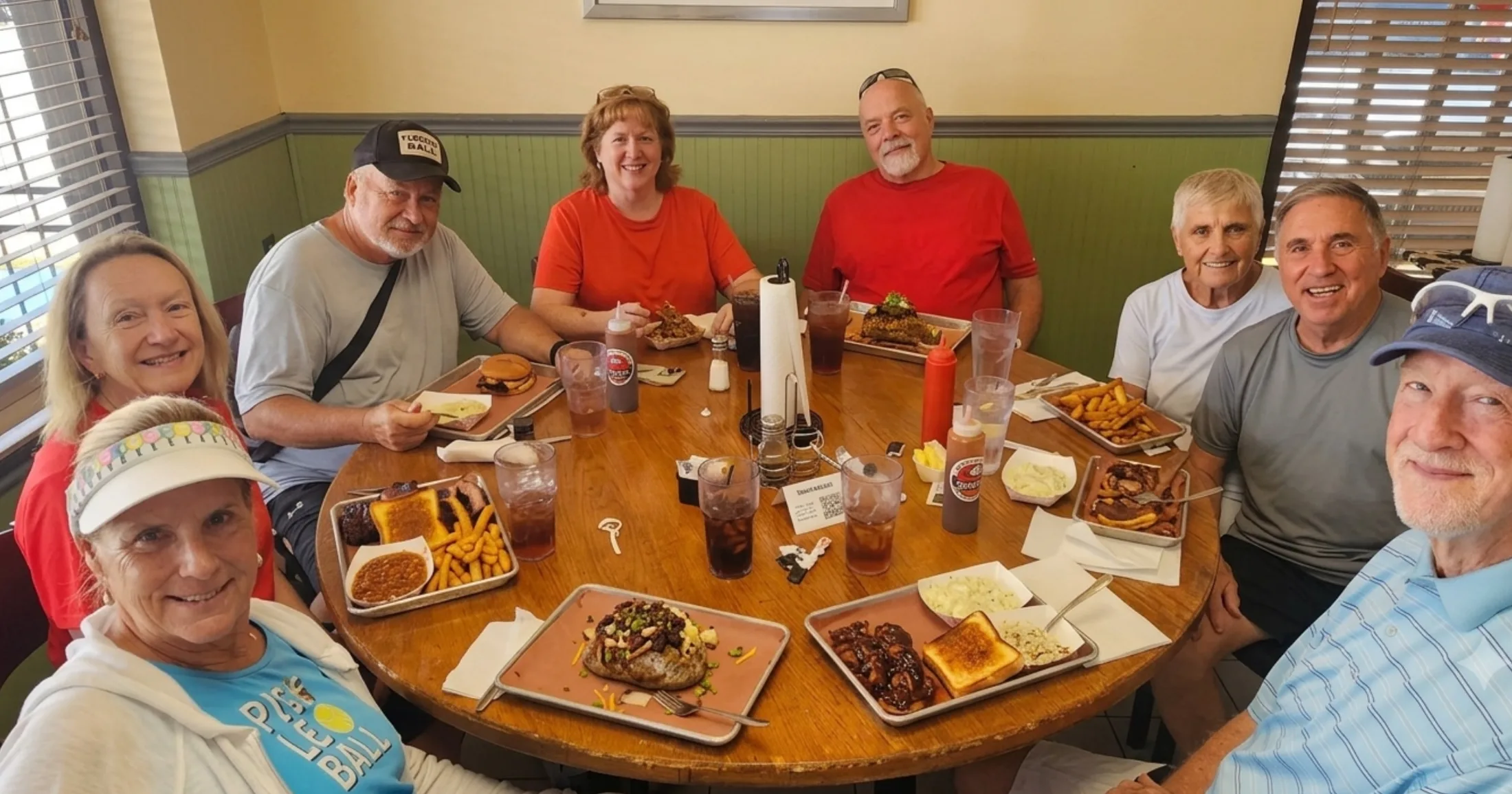 Group of pickleball regulars eating barbecue together at Pit Master Bar-B-Que, The Woodlands