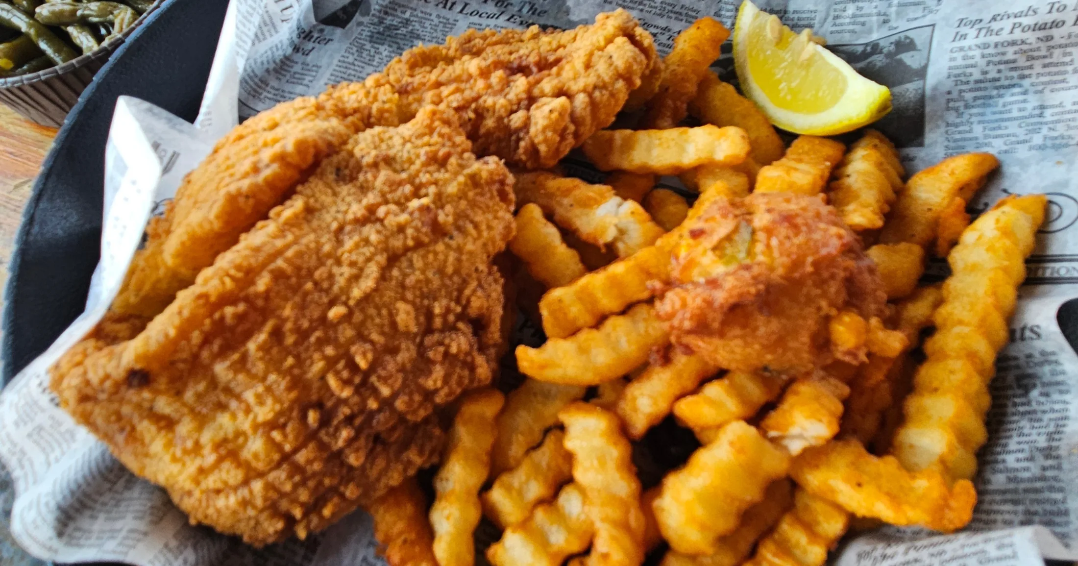 The Fried Grouper filet with crinkle fries, coleslaw, and cocktail sauce