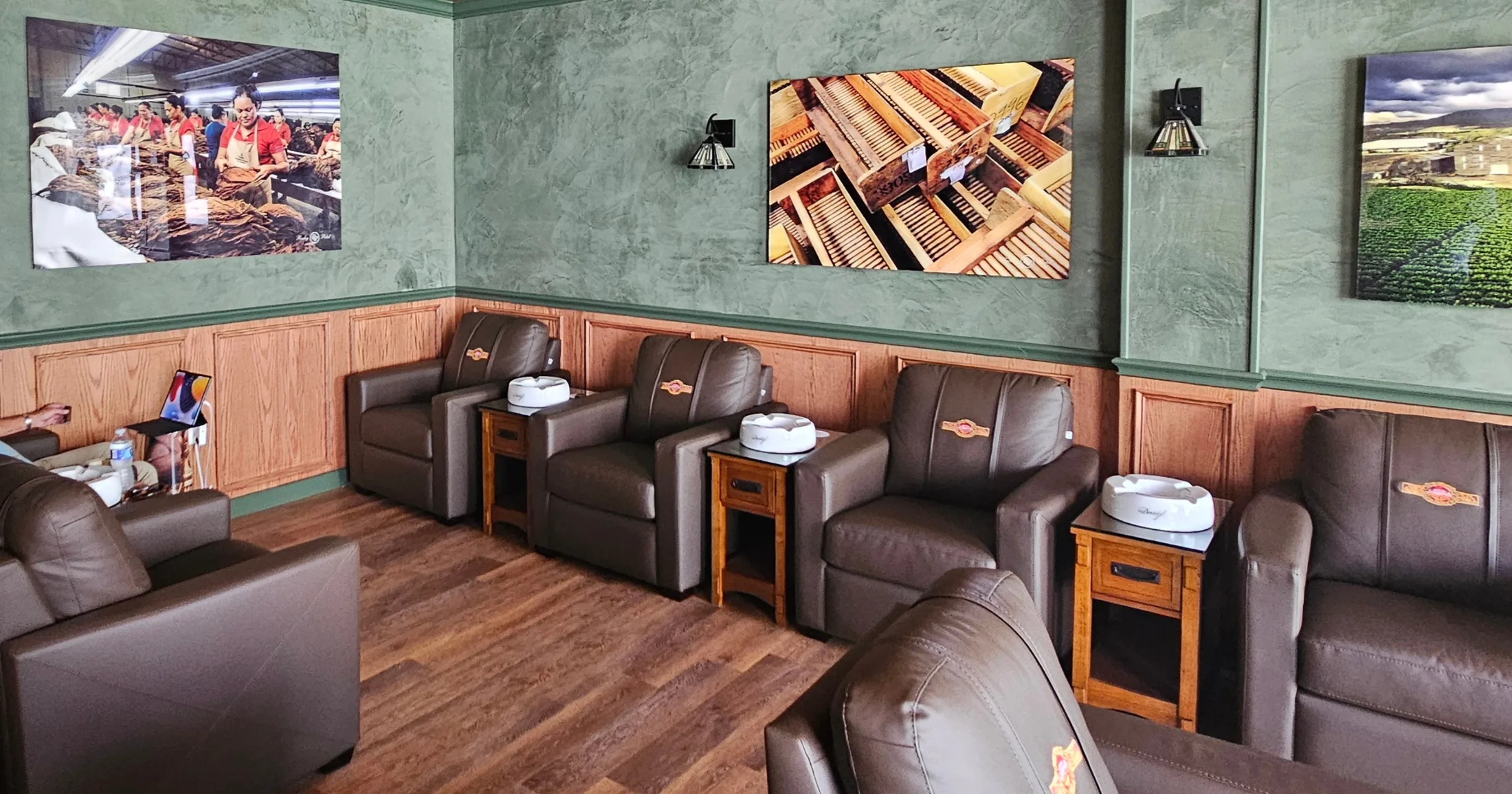 Member Only smoking lounge with leather recliners, wood-paneled walls, and cigar art photography