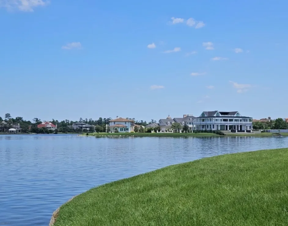 Luxury lakefront homes viewed across the water in The Woodlands