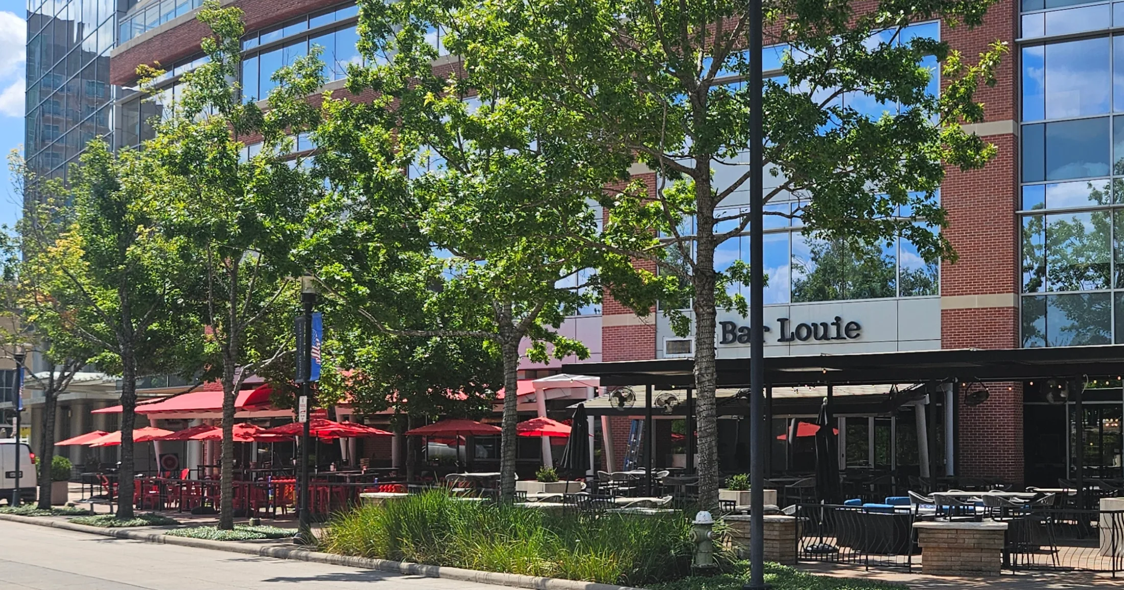 Restaurant row along a tree-lined street in The Woodlands Town Center