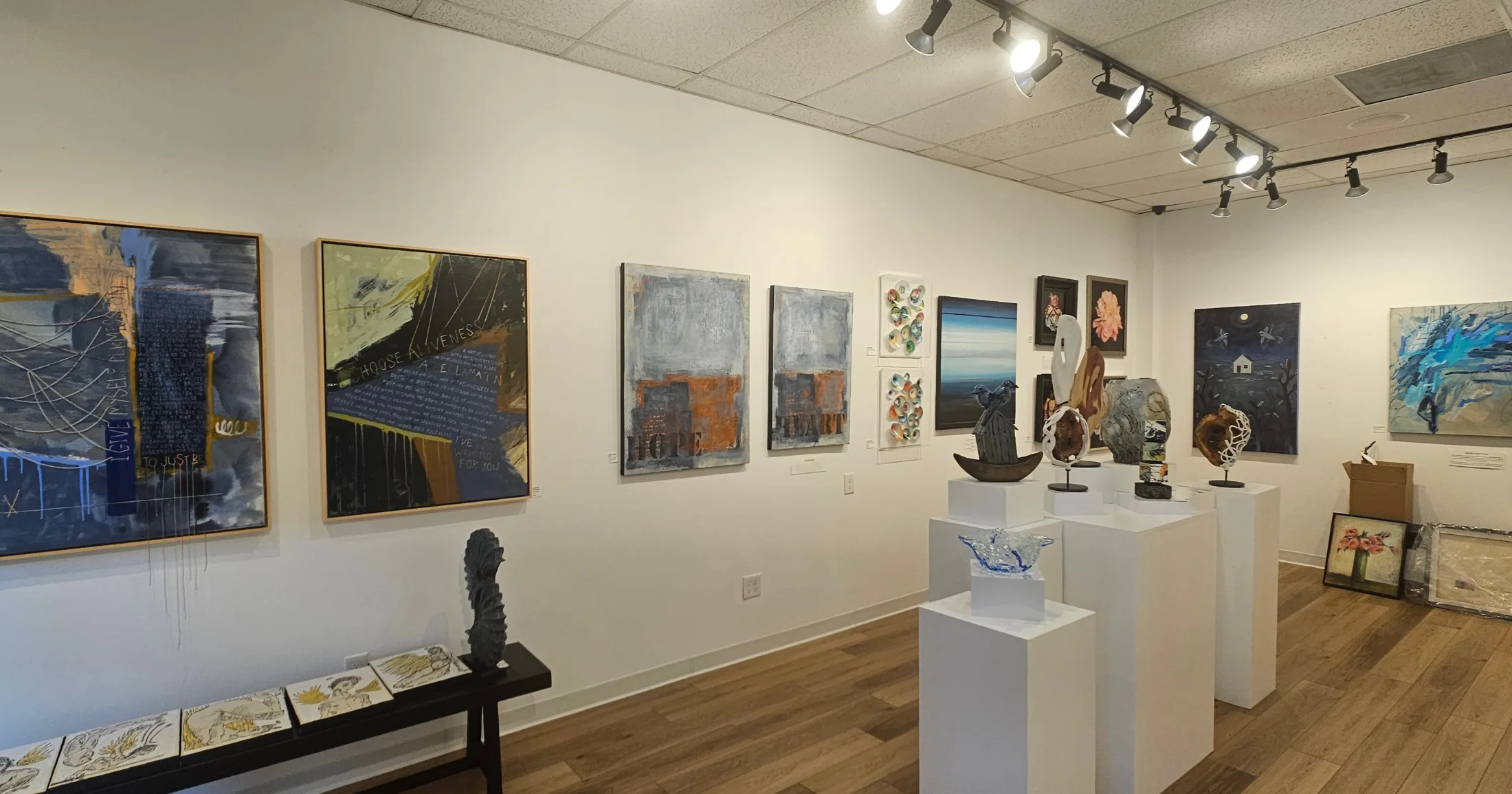 Wide view of Ardest Gallery interior with paintings and sculptures