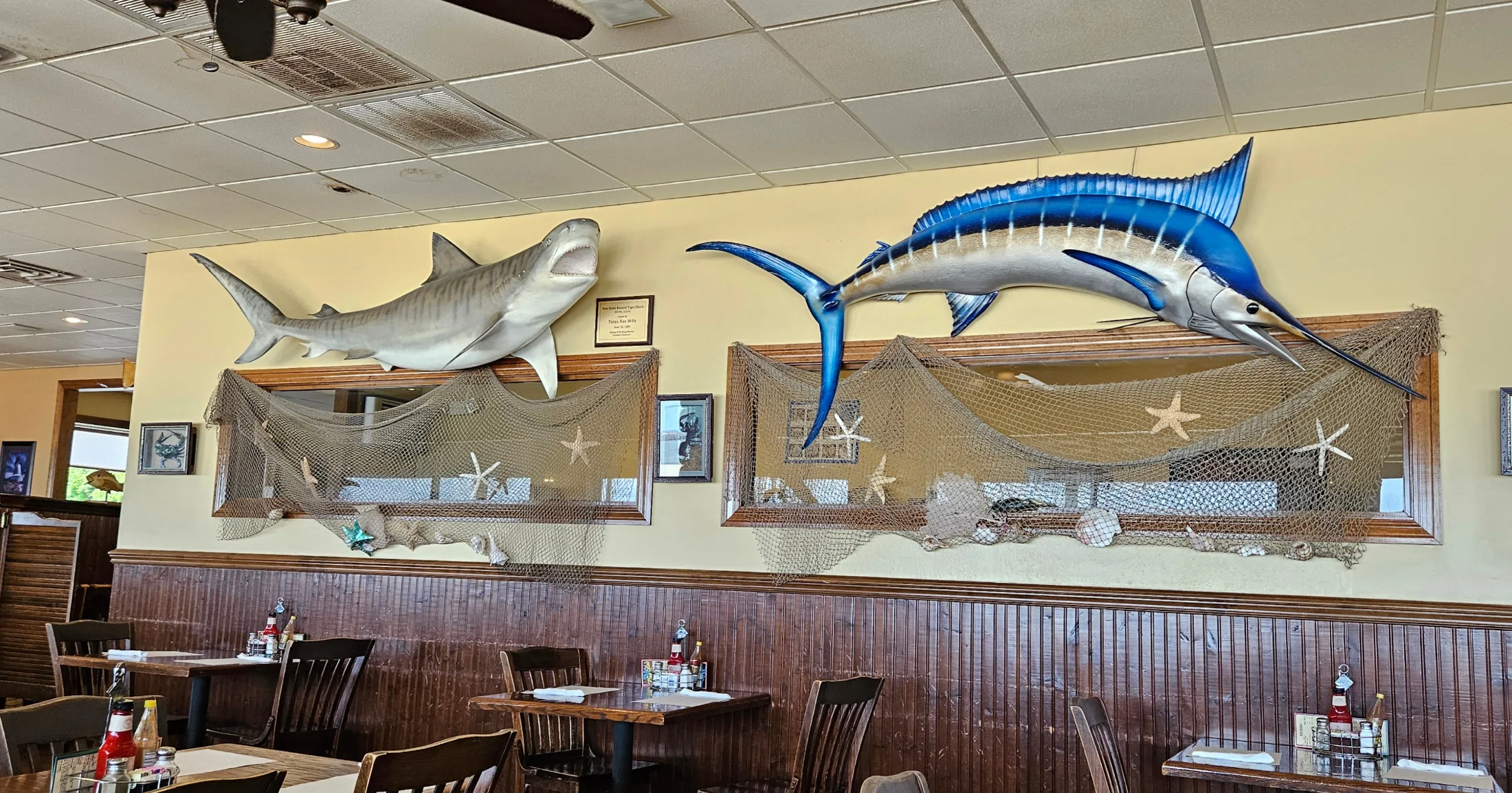 Dining room interior at White Cap with mounted shark and marlin on the walls