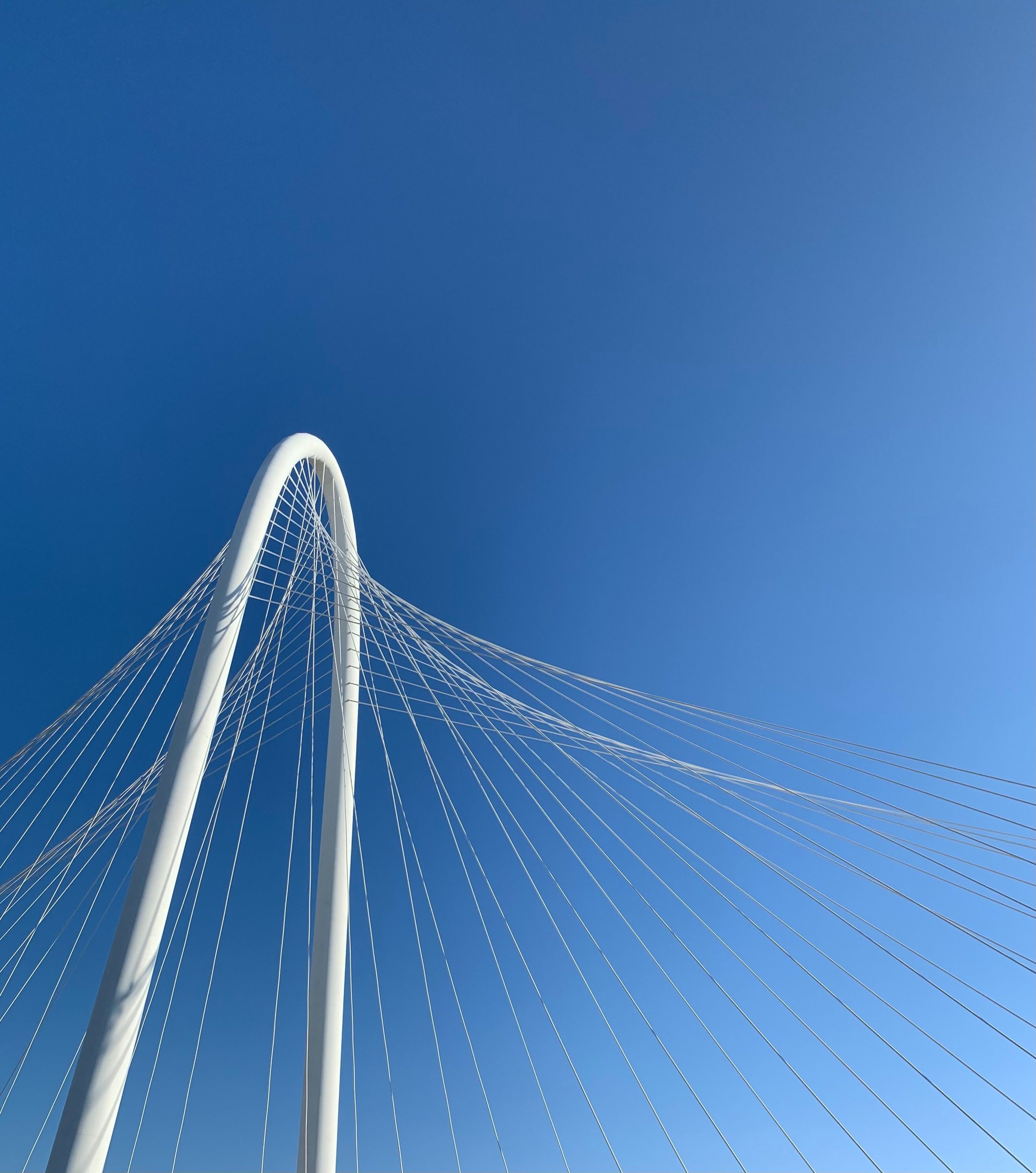 The white arch and cables of the Margaret Hunt Hill Bridge