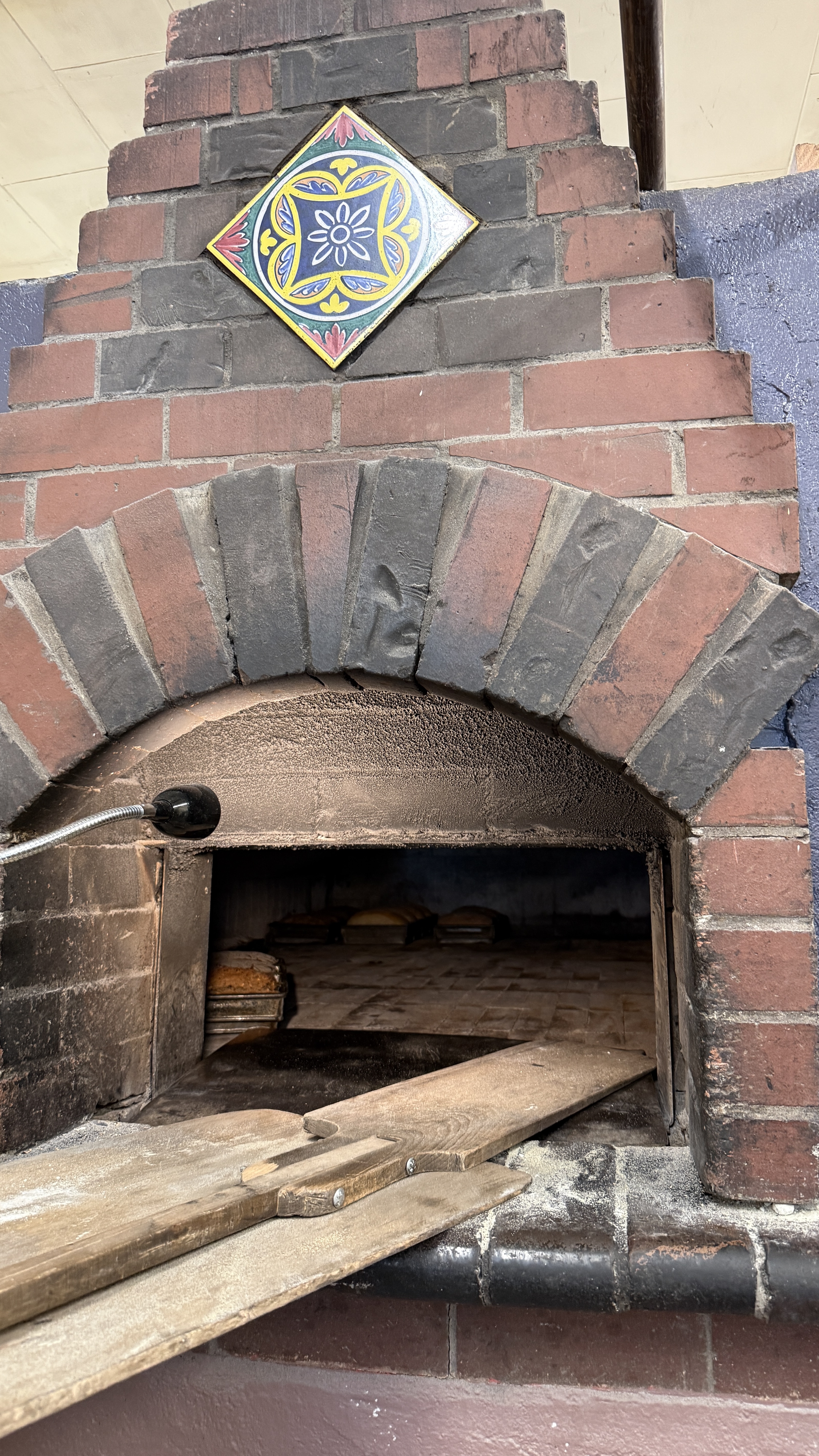Rebuilt brick oven with wooden peels