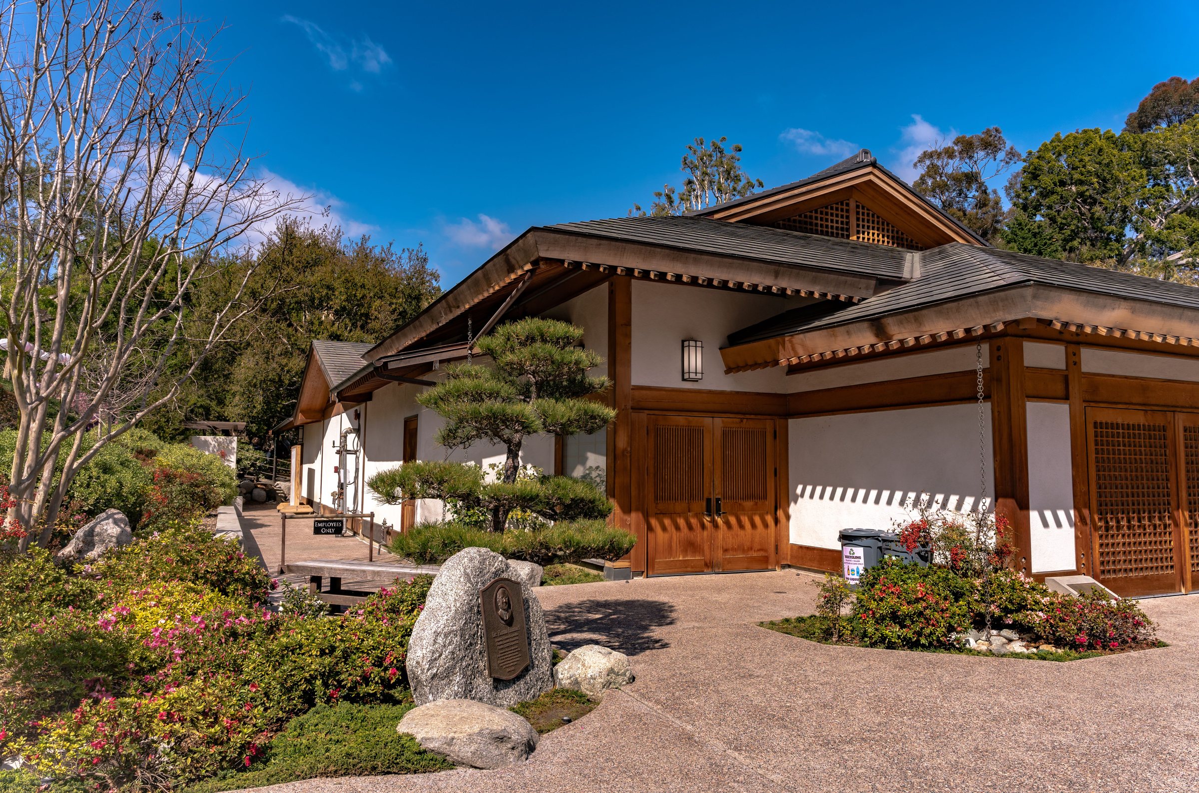 A traditional Japanese wooden building with a garden in Balboa Park, San Diego